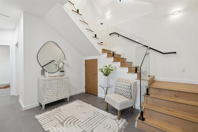 stairway featuring tile patterned floors and baseboards