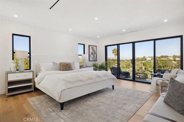 bedroom featuring access to outside, recessed lighting, and light wood-style floors