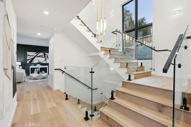 stairs featuring recessed lighting, baseboards, and wood finished floors