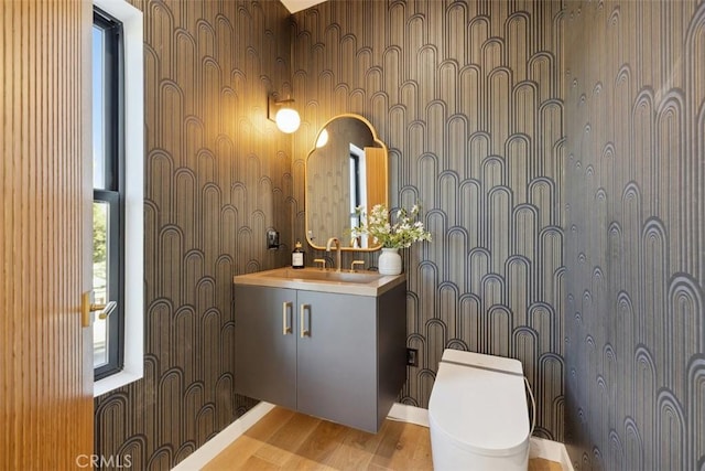 full bath featuring vanity and wood finished floors