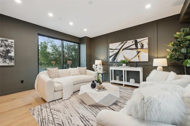 living room featuring recessed lighting, baseboards, and wood finished floors