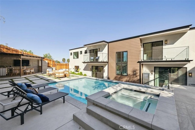 view of pool with a patio area, an outdoor living space, a pool with connected hot tub, and fence