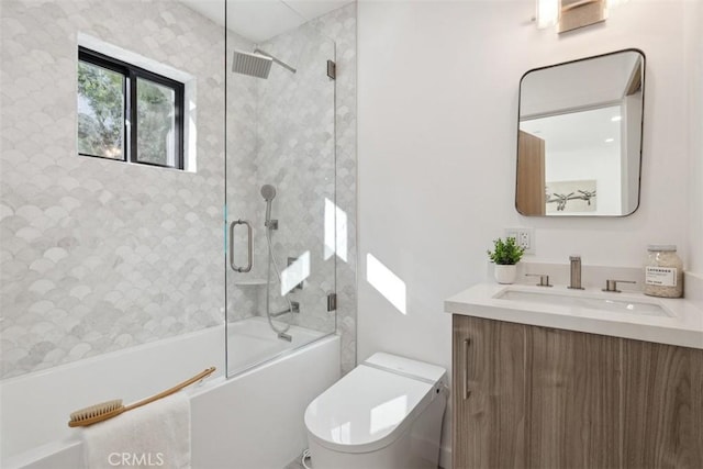 full bathroom with enclosed tub / shower combo, toilet, and vanity