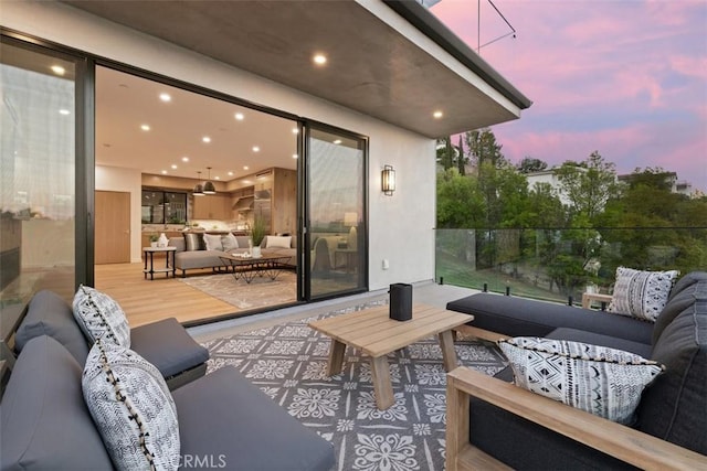 view of patio featuring an outdoor living space and a balcony