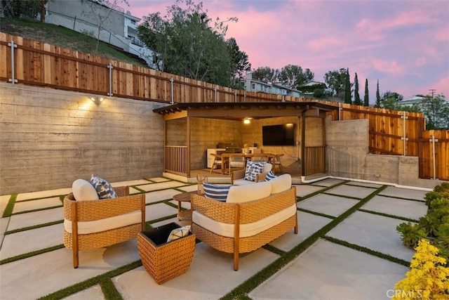 patio terrace at dusk with outdoor lounge area and fence