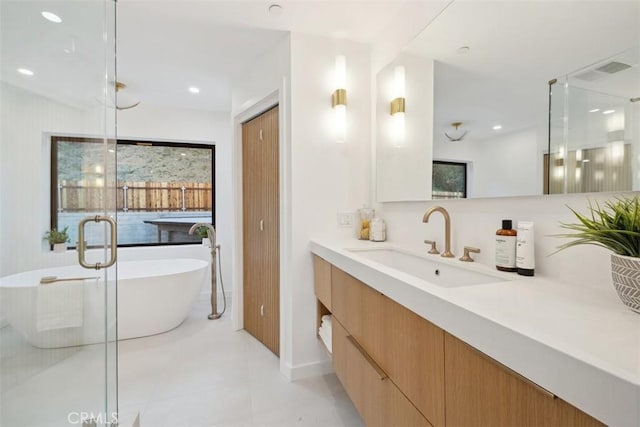 bathroom with vanity, visible vents, a freestanding tub, recessed lighting, and a shower stall