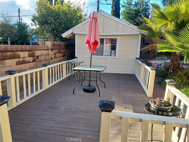 wooden deck featuring outdoor dining space