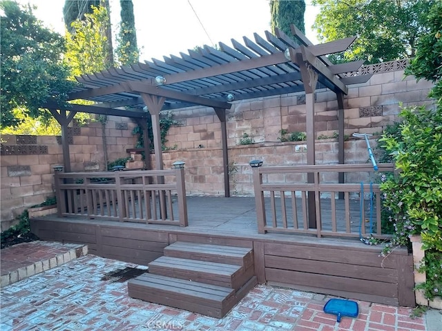 exterior space featuring fence, a wooden deck, and a pergola
