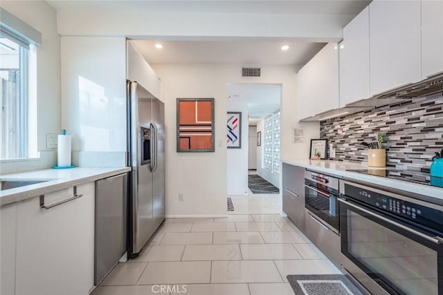 kitchen with visible vents, tasteful backsplash, white cabinetry, recessed lighting, and appliances with stainless steel finishes