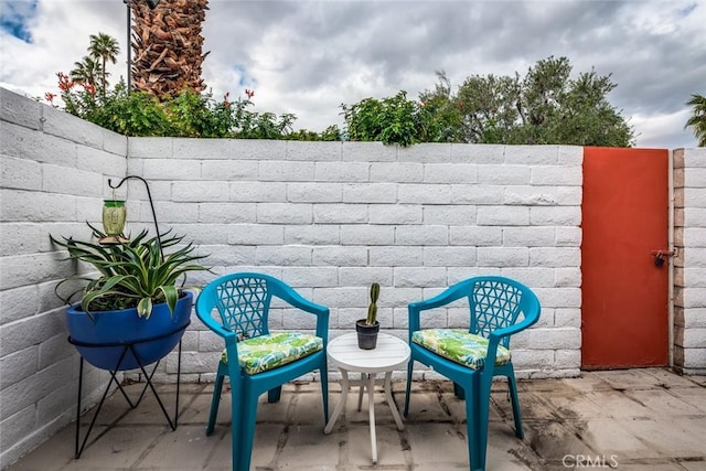 view of patio featuring fence