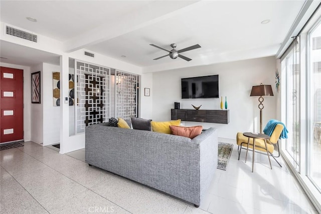 living area with a ceiling fan, a healthy amount of sunlight, and visible vents