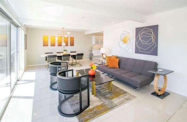 living room with tile patterned floors, baseboards, beam ceiling, and an inviting chandelier