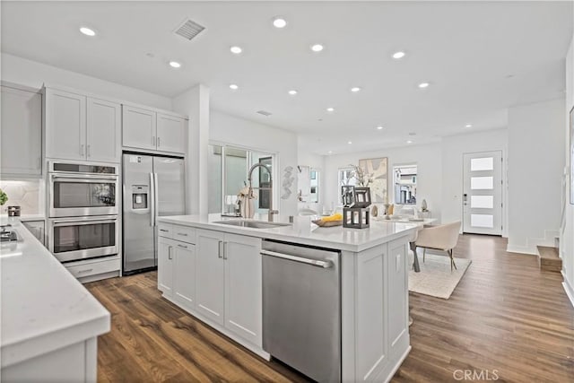 392 Baluster, Irvine, CA 92618 - kitchen featuring visible vents, a center island with sink, light countertops, appliances with stainless steel finishes, and a sink