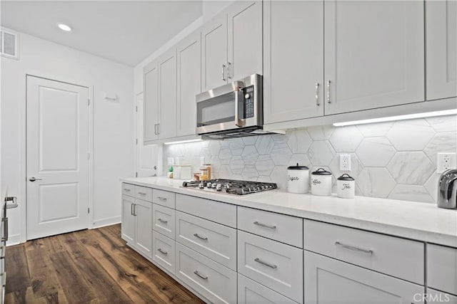 392 Baluster, Irvine, CA 92618 - kitchen with tasteful backsplash, light stone countertops, dark wood finished floors, appliances with stainless steel finishes, and white cabinets