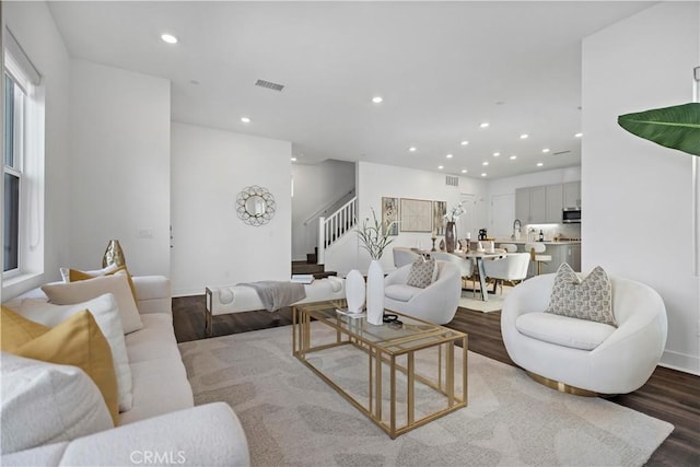 392 Baluster, Irvine, CA 92618 - living room featuring recessed lighting, visible vents, wood finished floors, and stairs