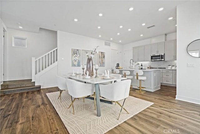 392 Baluster, Irvine, CA 92618 - dining room with recessed lighting, visible vents, wood finished floors, and stairway
