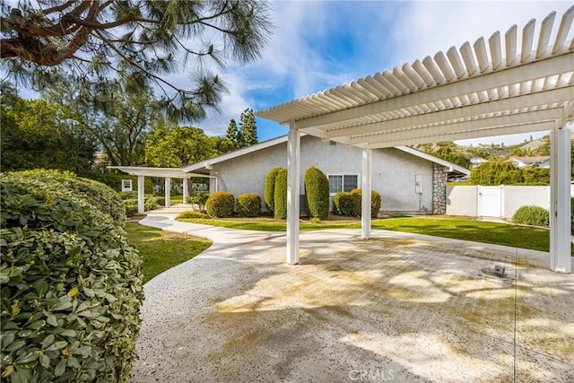 exterior space featuring a gate, a pergola, and fence