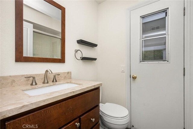 bathroom with vanity and toilet