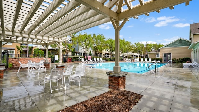 community pool with a patio area, fence, and a pergola