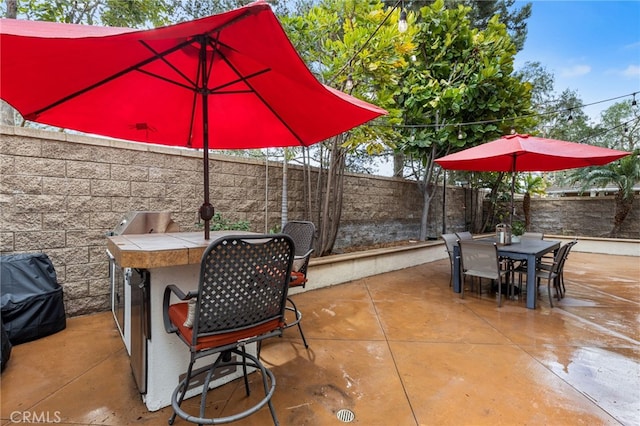 view of patio / terrace featuring outdoor dining area and a fenced backyard