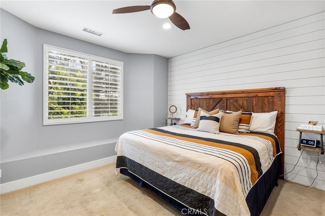 carpeted bedroom with a ceiling fan, baseboards, and visible vents