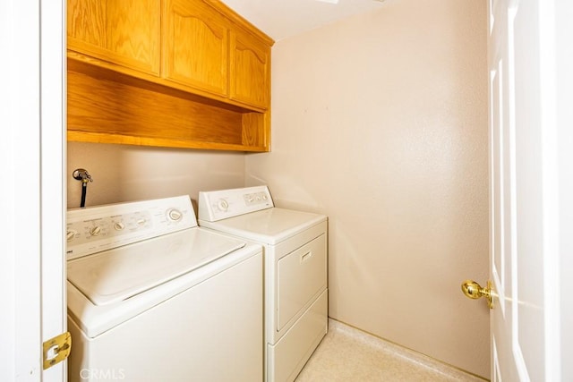 laundry area featuring washer and dryer and cabinet space