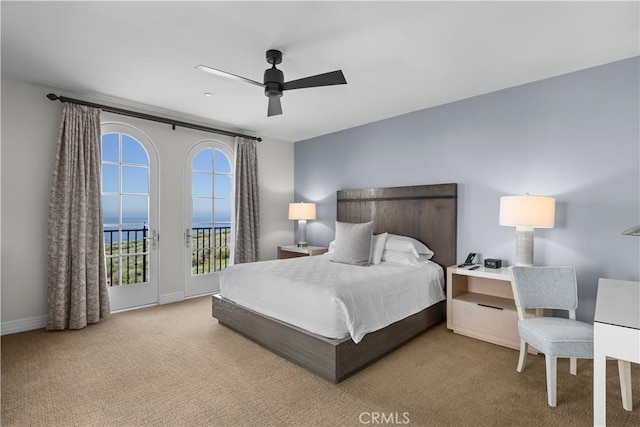 carpeted bedroom featuring access to outside, baseboards, and ceiling fan