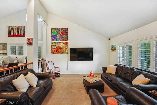 carpeted living area with vaulted ceiling