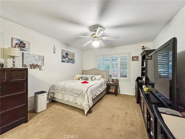 bedroom featuring a ceiling fan and light colored carpet