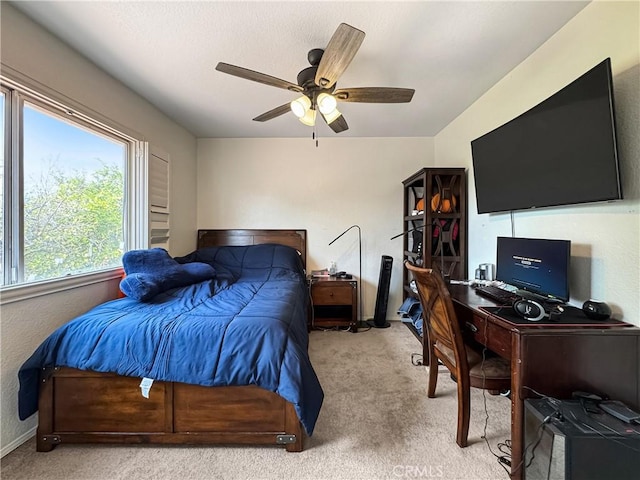 carpeted bedroom with baseboards and ceiling fan