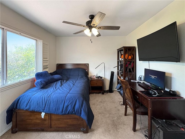 bedroom featuring ceiling fan, baseboards, and light carpet