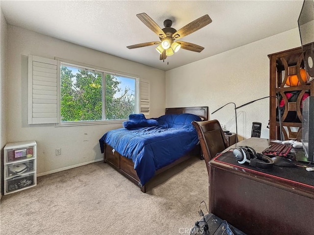 carpeted bedroom with baseboards, a textured ceiling, and a ceiling fan