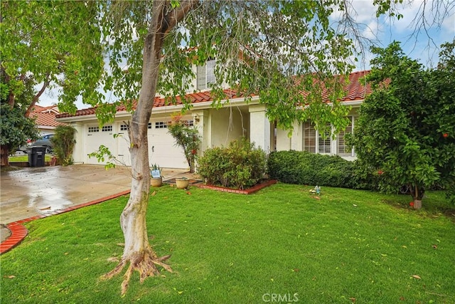 view of front of home with stucco siding, concrete driveway, a front lawn, and a tiled roof