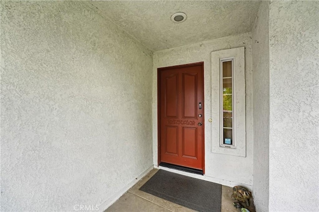 property entrance featuring stucco siding