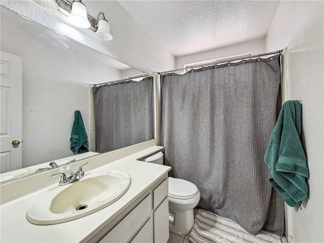 full bathroom featuring a shower with curtain, toilet, a textured ceiling, tile patterned flooring, and vanity