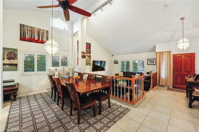 dining room featuring light tile patterned floors, high vaulted ceiling, a wealth of natural light, and ceiling fan with notable chandelier