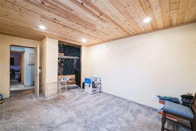 interior space with carpet flooring and wooden ceiling