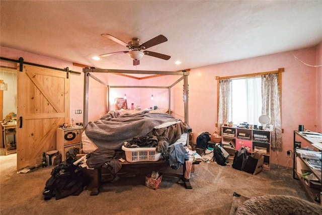 bedroom featuring a ceiling fan, a barn door, recessed lighting, and carpet