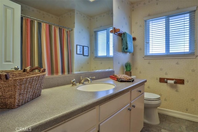 full bathroom with wallpapered walls, baseboards, toilet, tile patterned floors, and vanity