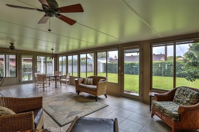 sunroom / solarium featuring plenty of natural light, lofted ceiling, and a ceiling fan