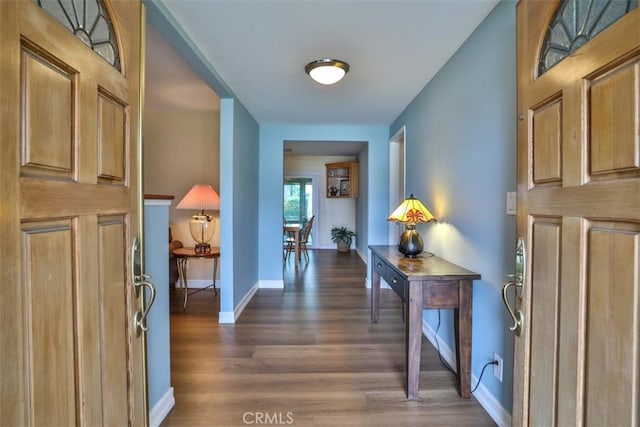 entrance foyer featuring dark wood-style floors and baseboards