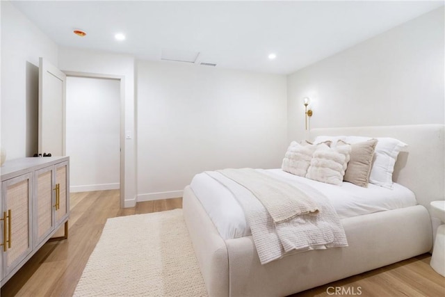 bedroom with recessed lighting, baseboards, and light wood-style floors