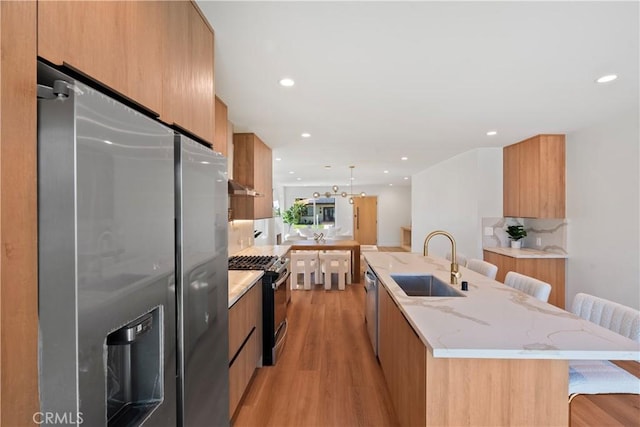 kitchen featuring a sink, modern cabinets, and appliances with stainless steel finishes