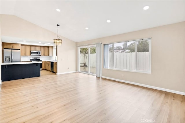 unfurnished living room featuring a chandelier, recessed lighting, baseboards, and light wood-style floors