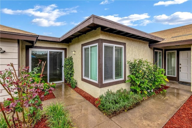 property entrance with stucco siding