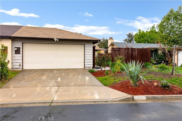 garage featuring concrete driveway