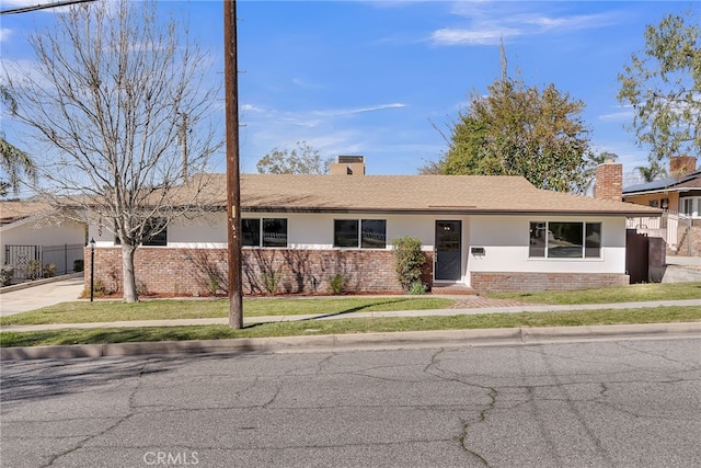 single story home with a front yard, fence, and a chimney