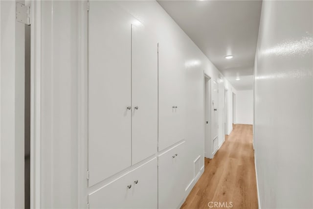 corridor featuring light wood finished floors