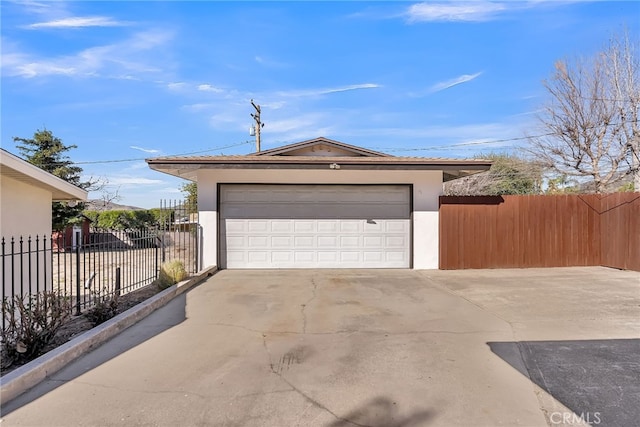 garage with driveway and fence