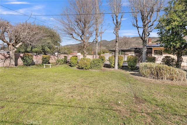 view of yard with a mountain view and fence